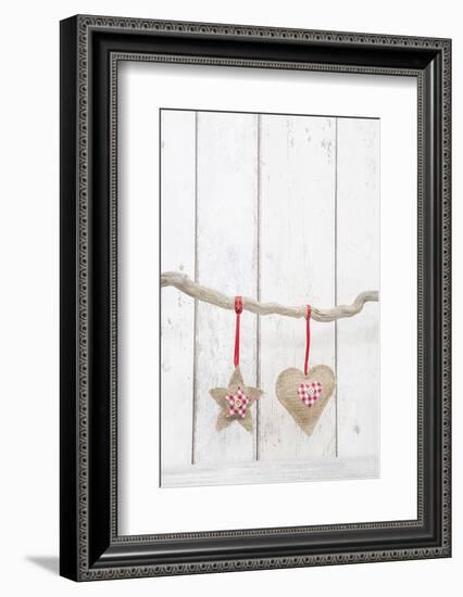 Christmas Ornaments Hanging in Front of White Wood-Andrea Haase-Framed Photographic Print