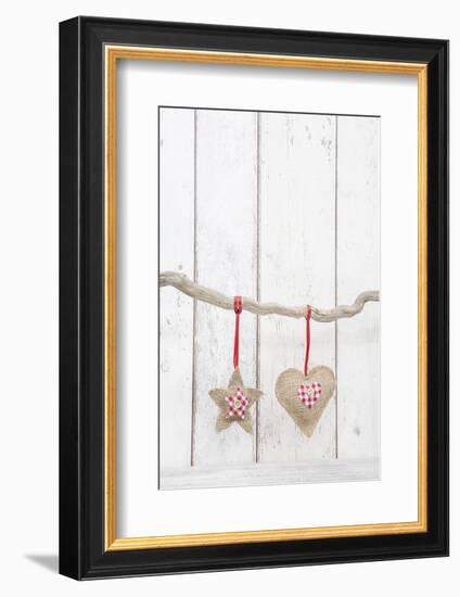 Christmas Ornaments Hanging in Front of White Wood-Andrea Haase-Framed Photographic Print