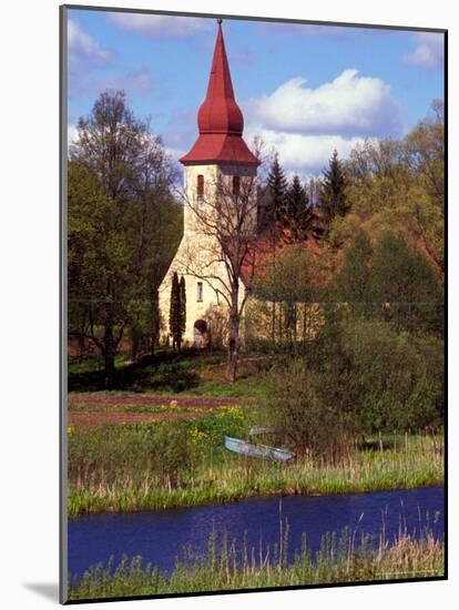 Church Nestled in Rural Landscape with Boat and Pond, Latvia-Janis Miglavs-Mounted Photographic Print