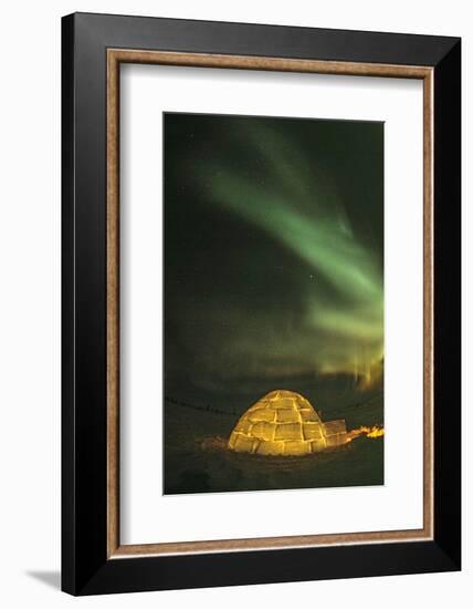 Churchill, Manitoba, Canada. Northern Lights shine above lit igloo.-Yvette Cardozo-Framed Photographic Print