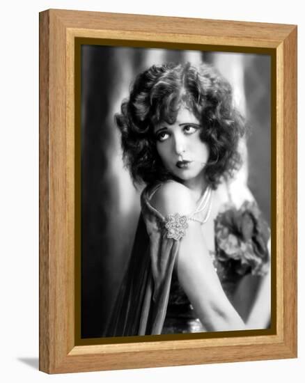 circa, 1929: Hollywood film star, Clara Bow (1905 - 1965) poses in a cape with jewelled clasp (b/w-null-Framed Stretched Canvas