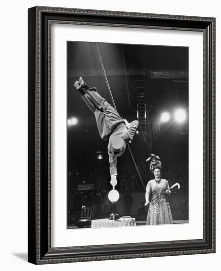 Circus Performer Balancer Unus Standing on His Index Finger on Globe Feet in Air Back of Head-Ralph Morse-Framed Photographic Print