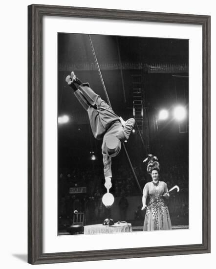 Circus Performer Balancer Unus Standing on His Index Finger on Globe Feet in Air Back of Head-Ralph Morse-Framed Photographic Print