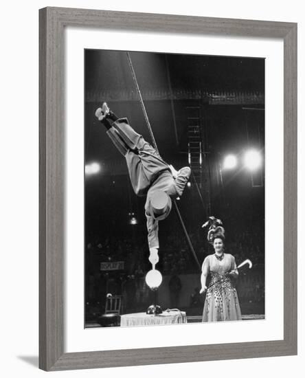 Circus Performer Balancer Unus Standing on His Index Finger on Globe Feet in Air Back of Head-Ralph Morse-Framed Photographic Print