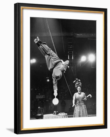 Circus Performer Balancer Unus Standing on His Index Finger on Globe Feet in Air Back of Head-Ralph Morse-Framed Photographic Print