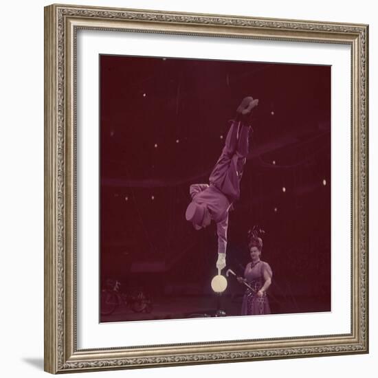 Circus Performer Balancing on Forefinger-Ralph Morse-Framed Photographic Print