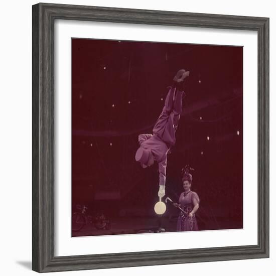 Circus Performer Balancing on Forefinger-Ralph Morse-Framed Photographic Print