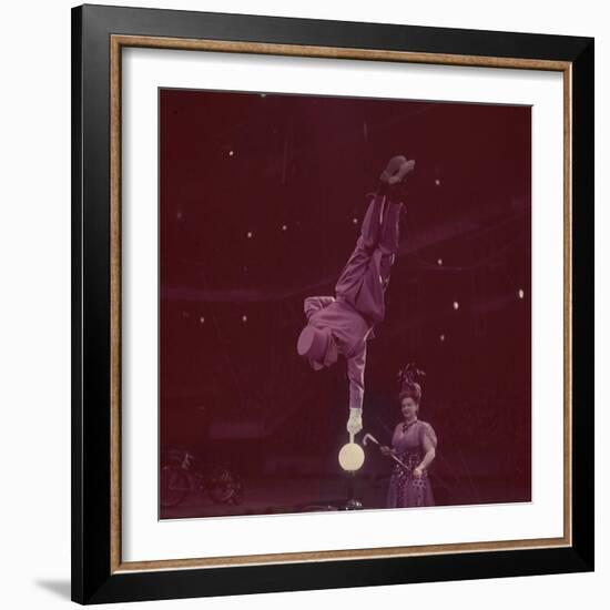 Circus Performer Balancing on Forefinger-Ralph Morse-Framed Photographic Print