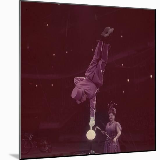 Circus Performer Balancing on Forefinger-Ralph Morse-Mounted Photographic Print