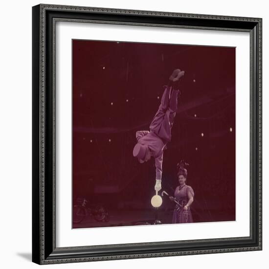 Circus Performer Balancing on Forefinger-Ralph Morse-Framed Photographic Print