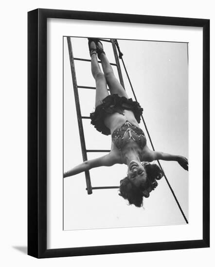 Circus Performer Hanging Upside Down-Cornell Capa-Framed Photographic Print