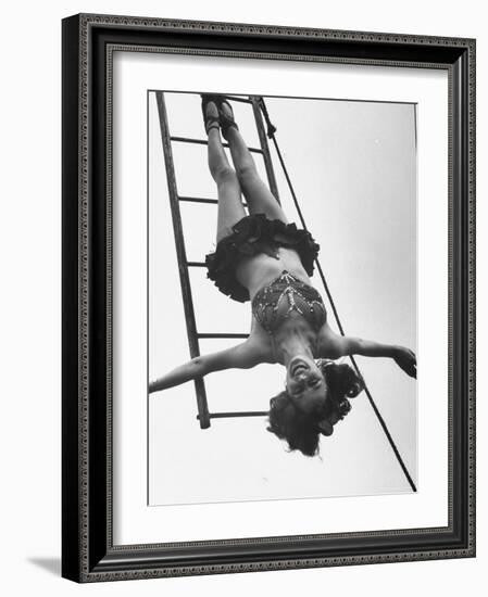 Circus Performer Hanging Upside Down-Cornell Capa-Framed Photographic Print