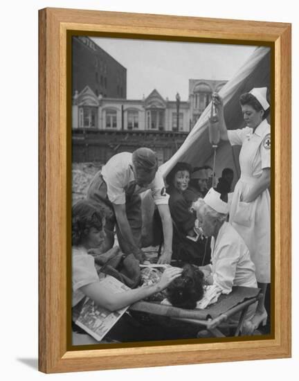 Civilian Receiving a Blood Transfusion from the British Red Cross Setup in a Tent-Allan Grant-Framed Premier Image Canvas