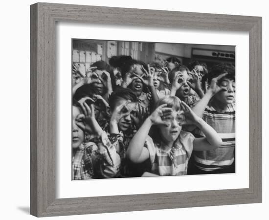 Classroom Full of Students Circling Fingers Around Eyes in Form of Glasses During Music Class-Francis Miller-Framed Photographic Print