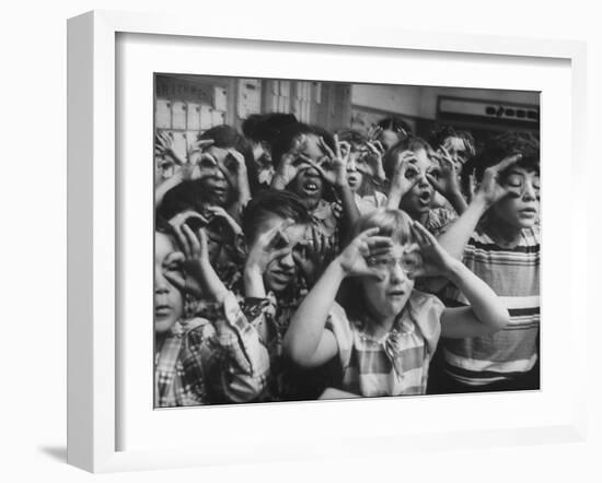 Classroom Full of Students Circling Fingers Around Eyes in Form of Glasses During Music Class-Francis Miller-Framed Photographic Print