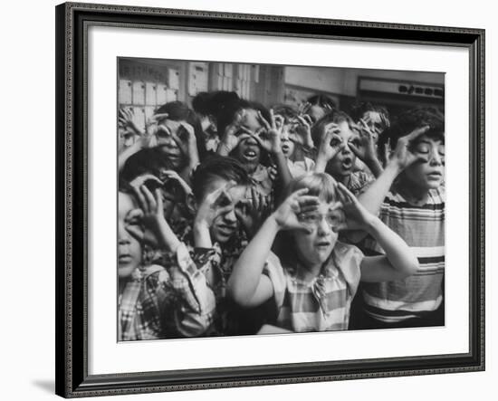 Classroom Full of Students Circling Fingers Around Eyes in Form of Glasses During Music Class-Francis Miller-Framed Photographic Print