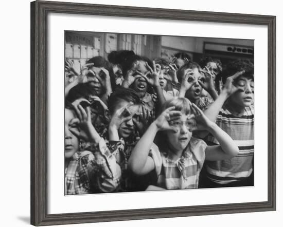 Classroom Full of Students Circling Fingers Around Eyes in Form of Glasses During Music Class-Francis Miller-Framed Photographic Print