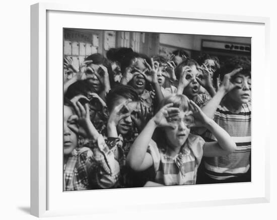 Classroom Full of Students Circling Fingers Around Eyes in Form of Glasses During Music Class-Francis Miller-Framed Photographic Print