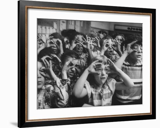 Classroom Full of Students Circling Fingers Around Eyes in Form of Glasses During Music Class-Francis Miller-Framed Photographic Print