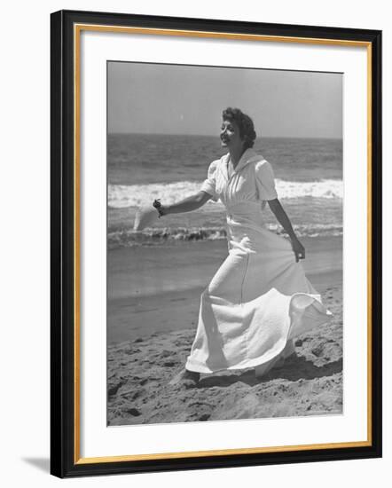 Claudette Colbert in Zippered, Terry Cloth Beach Robe, Sashaying Along Surf at Santa Monica Beach-Peter Stackpole-Framed Premium Photographic Print