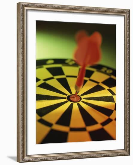 Close-up of a Dart in the Bull's-Eye of a Dartboard-null-Framed Photographic Print