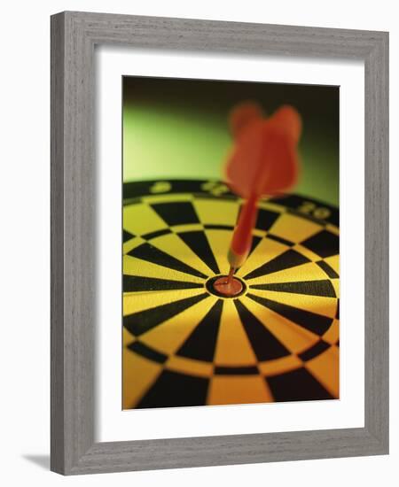 Close-up of a Dart in the Bull's-Eye of a Dartboard-null-Framed Photographic Print