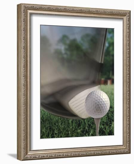 Close-up of a Golf Club Hitting a Golf Ball on a Tee-null-Framed Photographic Print