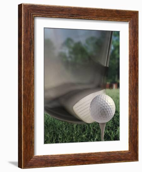Close-up of a Golf Club Hitting a Golf Ball on a Tee-null-Framed Photographic Print