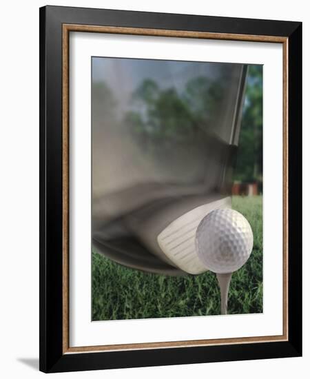 Close-up of a Golf Club Hitting a Golf Ball on a Tee-null-Framed Photographic Print