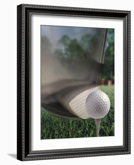 Close-up of a Golf Club Hitting a Golf Ball on a Tee-null-Framed Photographic Print