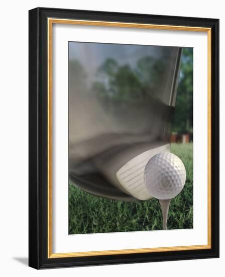 Close-up of a Golf Club Hitting a Golf Ball on a Tee-null-Framed Photographic Print