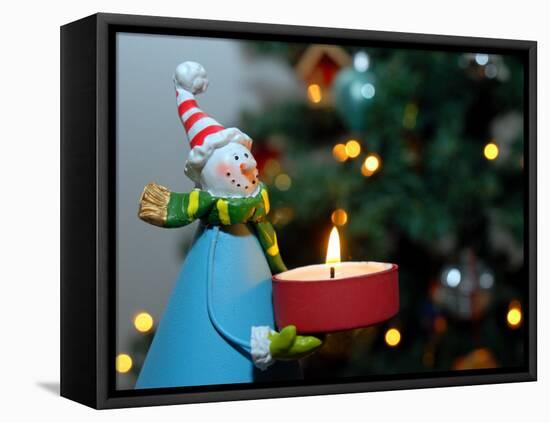 Close-Up of a Snow Man Candle in Front of a Tree with Christmas Lights-Winfred Evers-Framed Premier Image Canvas