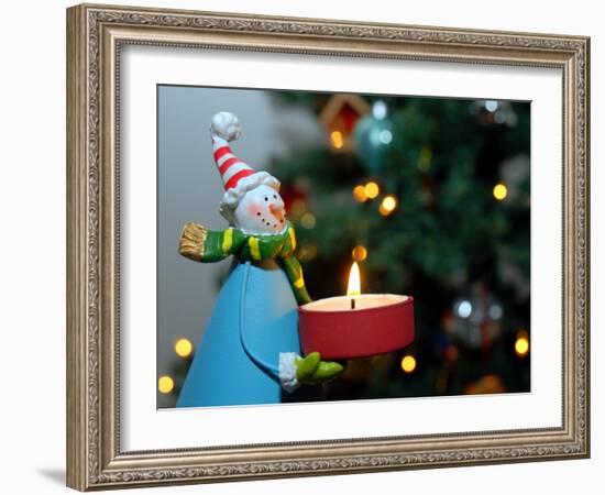 Close-Up of a Snow Man Candle in Front of a Tree with Christmas Lights-Winfred Evers-Framed Photographic Print