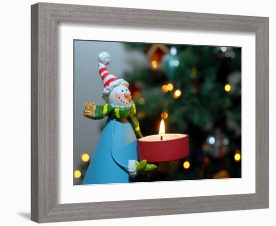 Close-Up of a Snow Man Candle in Front of a Tree with Christmas Lights-Winfred Evers-Framed Photographic Print