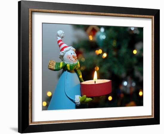 Close-Up of a Snow Man Candle in Front of a Tree with Christmas Lights-Winfred Evers-Framed Photographic Print