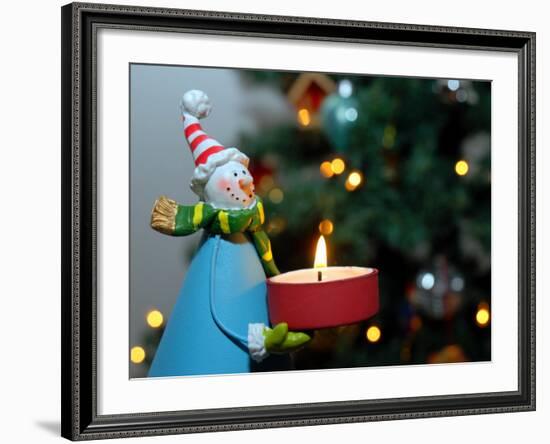 Close-Up of a Snow Man Candle in Front of a Tree with Christmas Lights-Winfred Evers-Framed Photographic Print