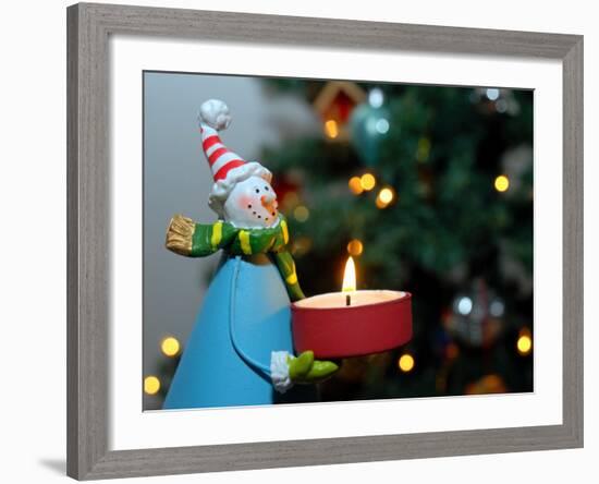 Close-Up of a Snow Man Candle in Front of a Tree with Christmas Lights-Winfred Evers-Framed Photographic Print