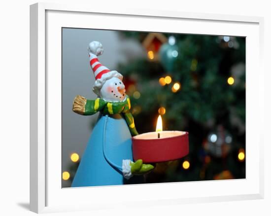 Close-Up of a Snow Man Candle in Front of a Tree with Christmas Lights-Winfred Evers-Framed Photographic Print