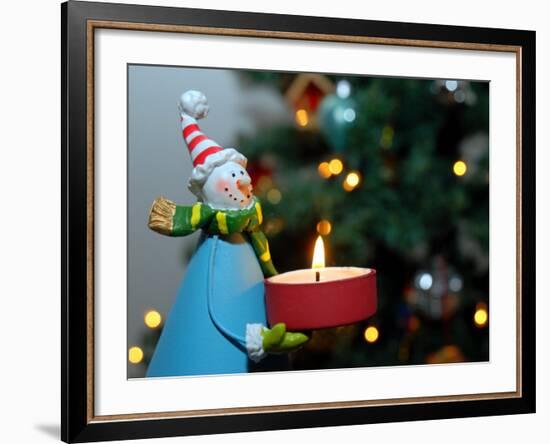 Close-Up of a Snow Man Candle in Front of a Tree with Christmas Lights-Winfred Evers-Framed Photographic Print