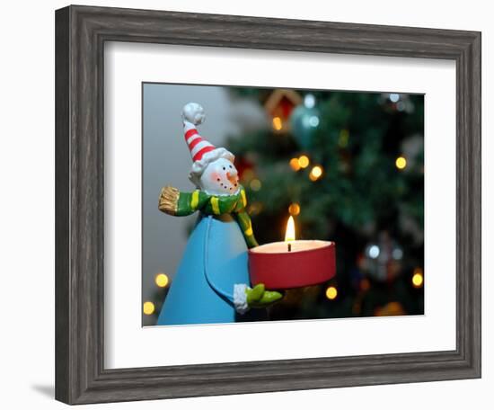 Close-Up of a Snow Man Candle in Front of a Tree with Christmas Lights-Winfred Evers-Framed Photographic Print