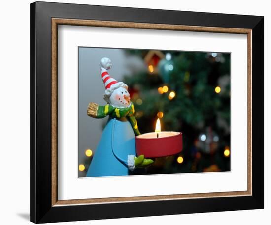 Close-Up of a Snow Man Candle in Front of a Tree with Christmas Lights-Winfred Evers-Framed Photographic Print