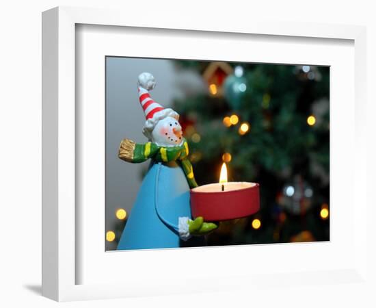 Close-Up of a Snow Man Candle in Front of a Tree with Christmas Lights-Winfred Evers-Framed Photographic Print