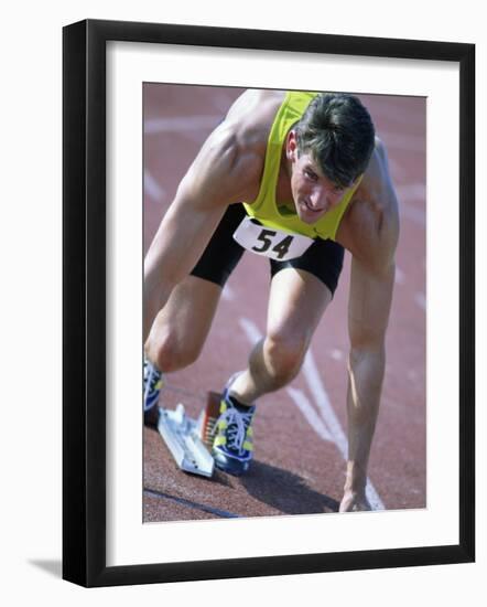 Close-up of a Young Man in the Starting Position on a Running Track-null-Framed Photographic Print