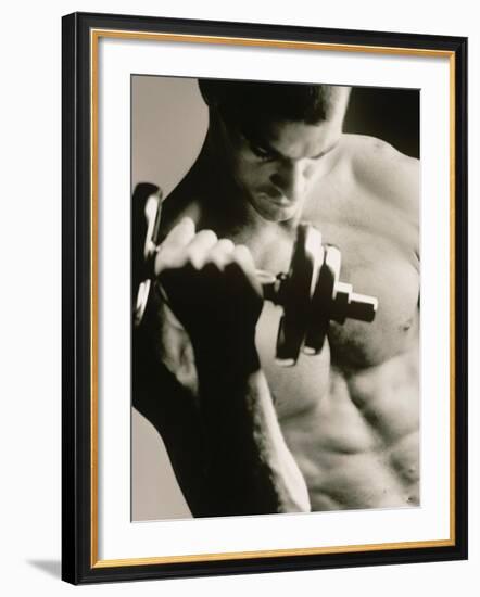 Close-up of a Young Man Working Out with a Dumbbell--Framed Photographic Print