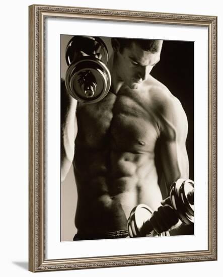 Close-up of a Young Man Working Out with Dumbbells--Framed Photographic Print