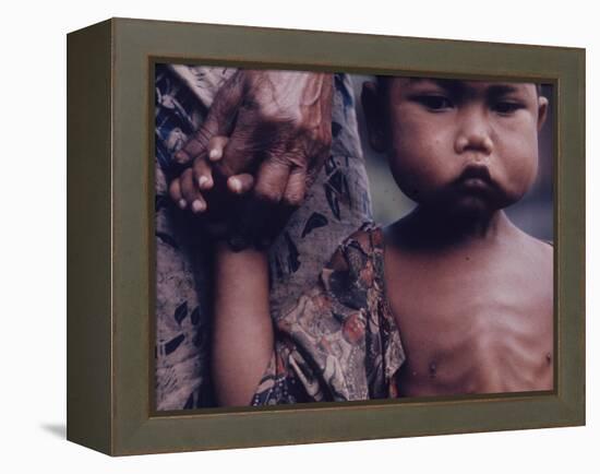 Close-Up of an Indonesian Child Holding on to the Hand of His Mother-Co Rentmeester-Framed Premier Image Canvas