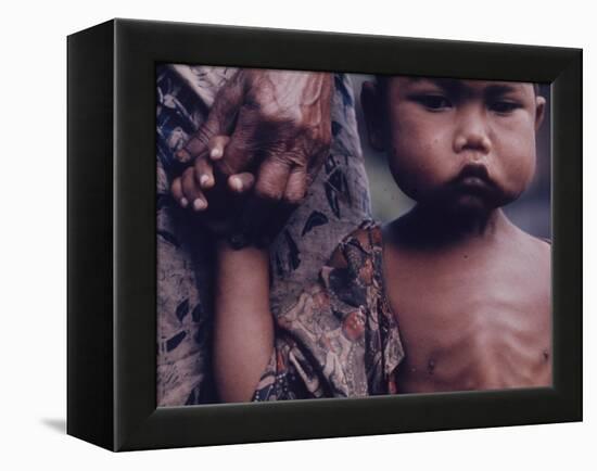 Close-Up of an Indonesian Child Holding on to the Hand of His Mother-Co Rentmeester-Framed Premier Image Canvas