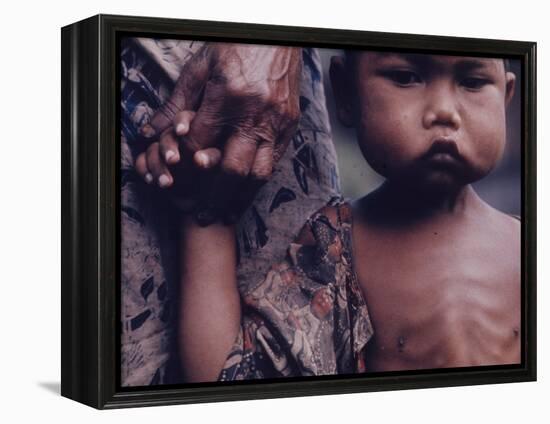 Close-Up of an Indonesian Child Holding on to the Hand of His Mother-Co Rentmeester-Framed Premier Image Canvas
