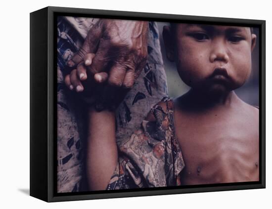 Close-Up of an Indonesian Child Holding on to the Hand of His Mother-Co Rentmeester-Framed Premier Image Canvas