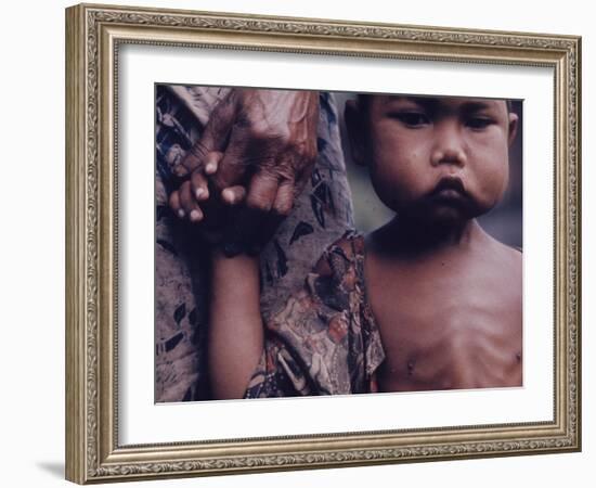 Close-Up of an Indonesian Child Holding on to the Hand of His Mother-Co Rentmeester-Framed Photographic Print